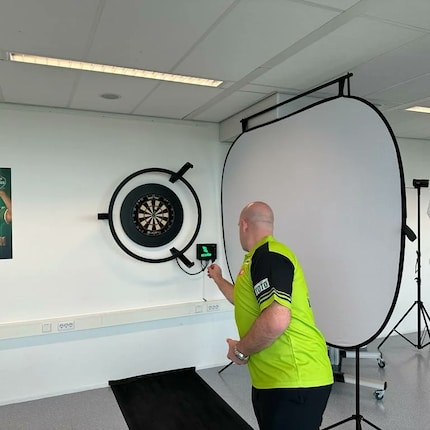 Ex-Dart World Champion Michael van Gerwen throwing.